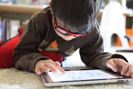 Kid using an iPad.