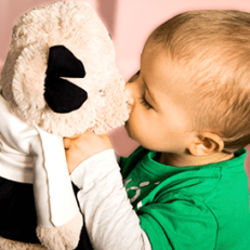 Kid playing with a stuffed bear toy