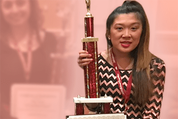 Julia holding her trophy