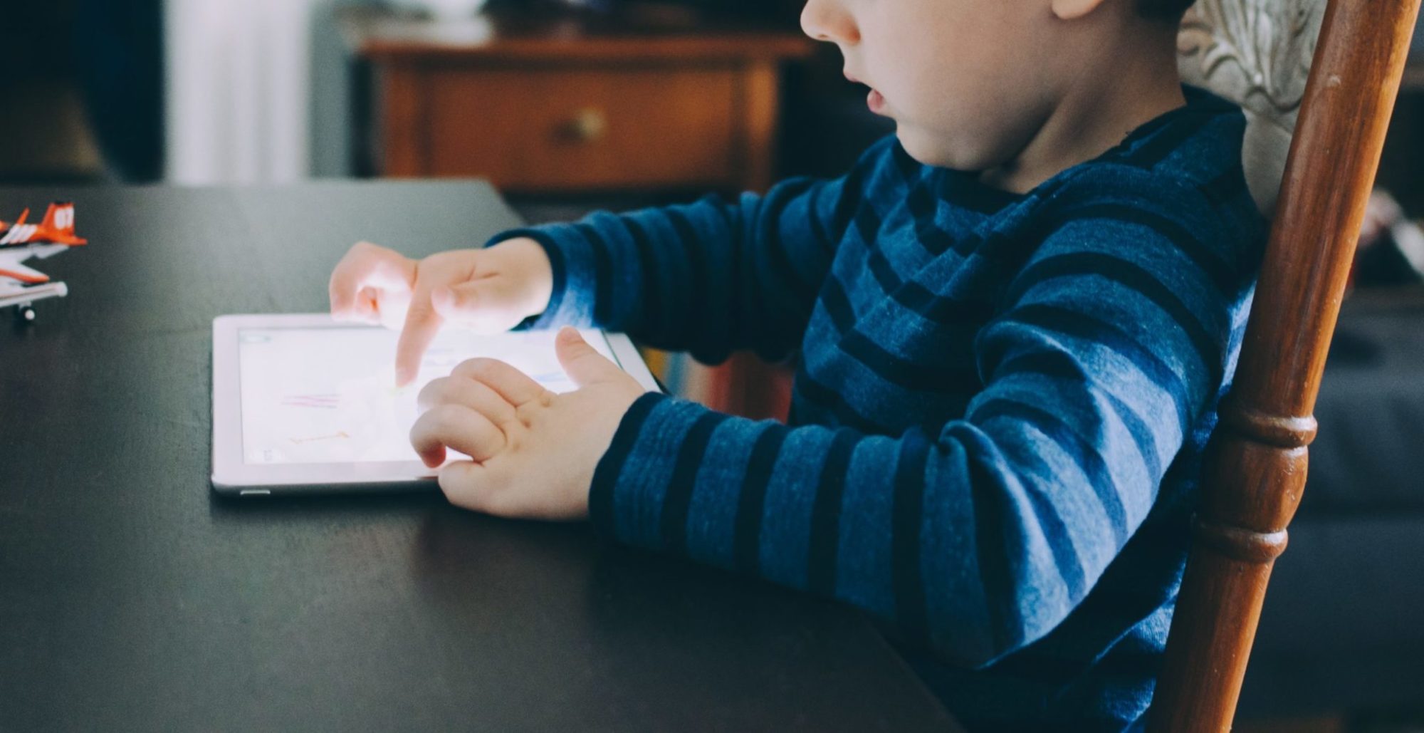 a child touches a tablet