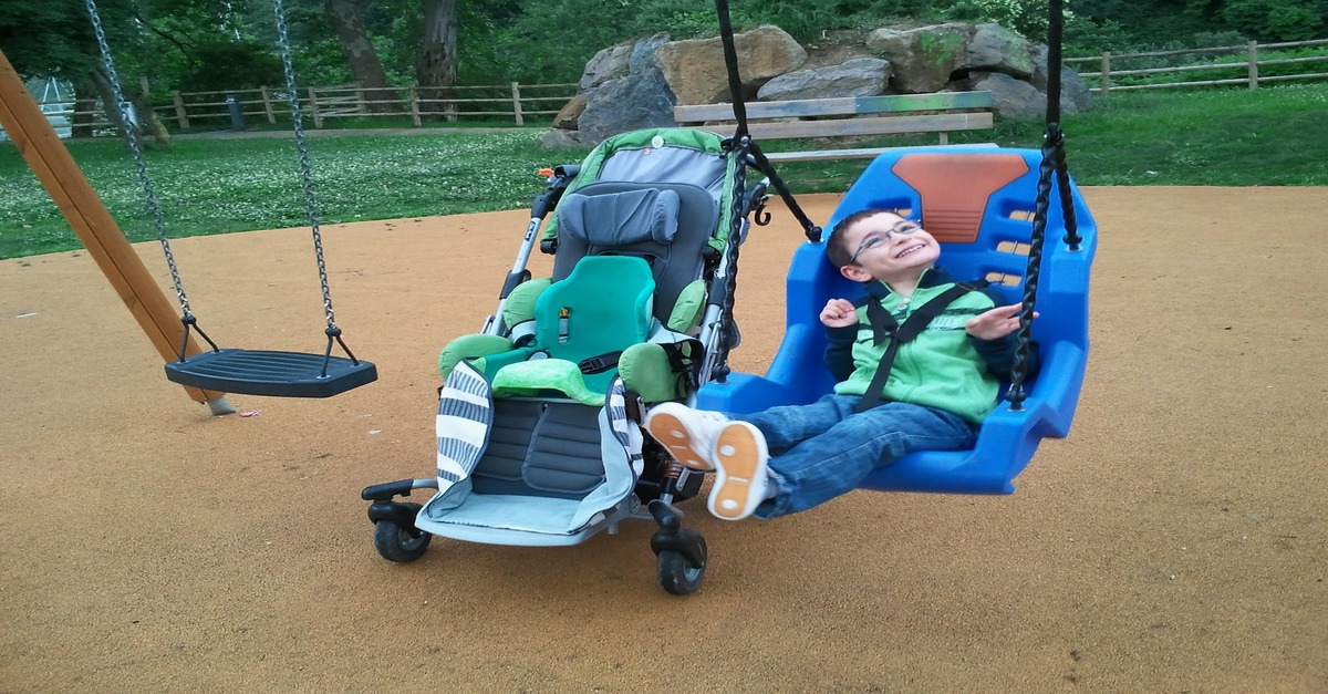 A child with cerebral palsy on a swing