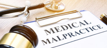 A piece of paper with the words medical malpractice on it