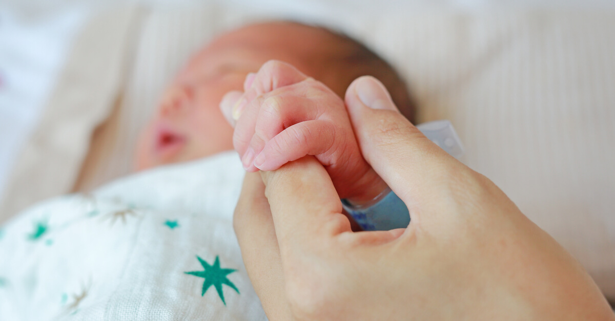 mother holding newborn