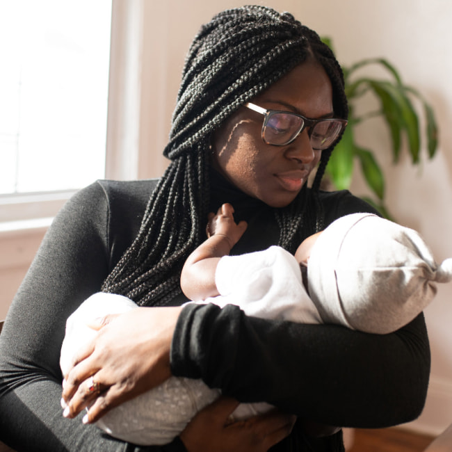 A woman holds a baby.