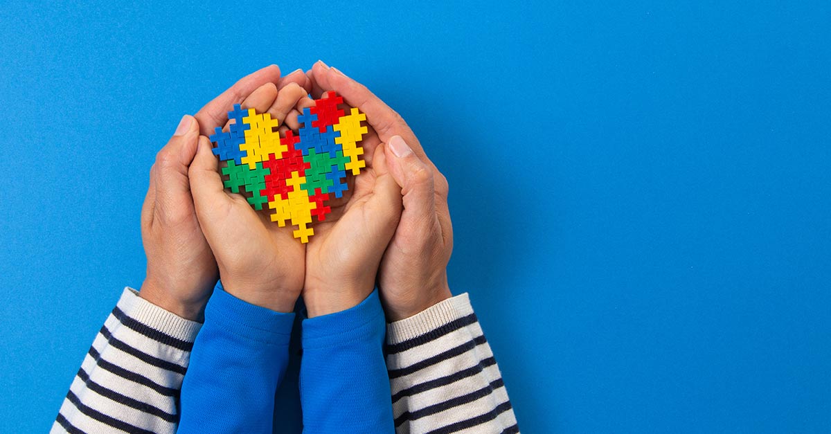 Child and parent holding a handful of puzzle pieces.