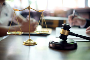 The scales of justice and a gavel are shown.