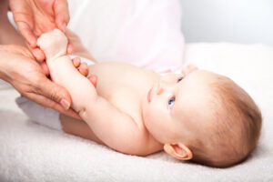 Nurse checking a baby's arm movement