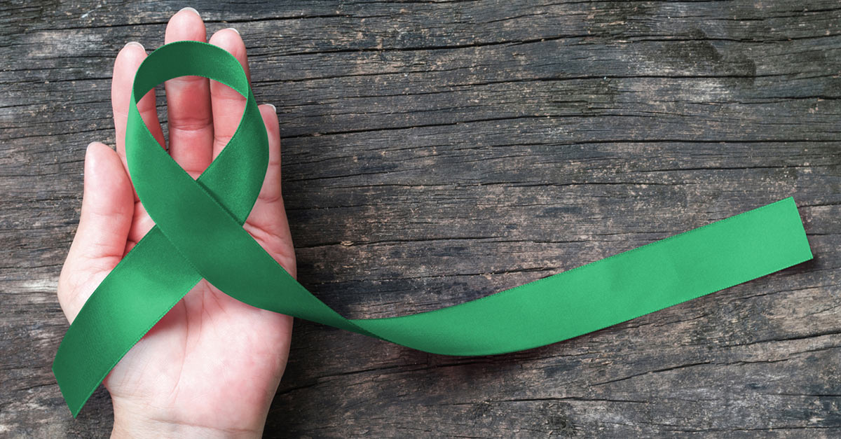 green ribbon in hand