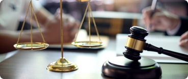 A birth injury lawsuit takes place at a desk with a gavel and the scales of justice.