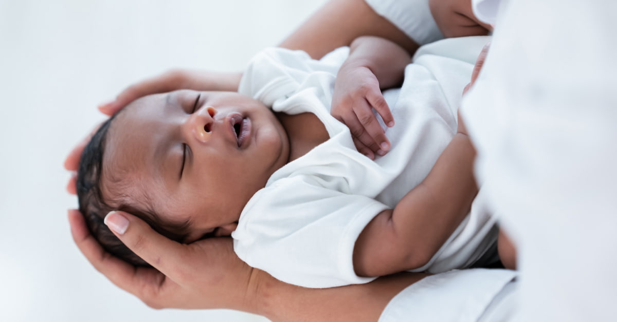 Parent holds newborn baby